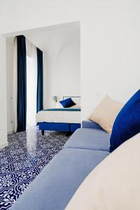 a bedroom with two beds with blue and white at Hotel Da Raffaele in Ischia