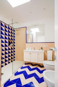 a bathroom with a toilet and a sink and a mirror at Hotel Da Raffaele in Ischia