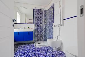 a blue and white bathroom with a shower and a sink at Hotel Da Raffaele in Ischia