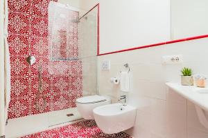 a white bathroom with a toilet and a shower at Hotel Da Raffaele in Ischia