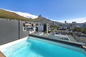 a swimming pool on the roof of a building with a view at One26 On M Luxury serviced apartments - By Elevate in Cape Town