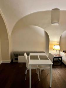 a white table and chairs in a room at Maison Petit Bonbon in Turin