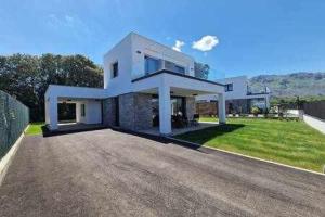 a large white house with a large driveway at Chalet A un paso de Llanes in Llanes