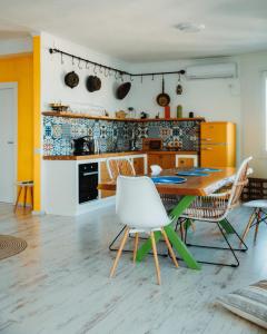 a kitchen with a table and chairs in a room at Beachfront Marilyn in Durrës