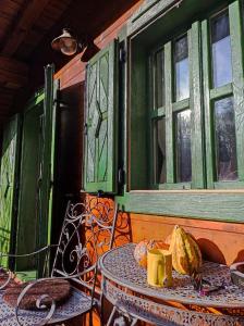 a table and chairs on a porch with a window at Vintage riverside house Slapnica, in the Žumberak Nature Park, finnish sauna and jacuzzi in Krašić