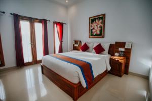 A bed or beds in a room at The Dagan Bungalow
