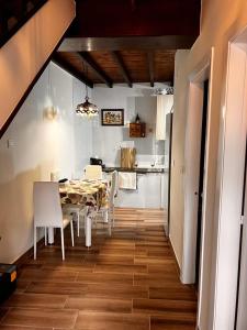 a dining room and kitchen with a table and chairs at La Casina de MIRI in Tazones