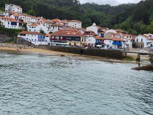 a town next to a body of water with houses at La Casina de MIRI in Tazones