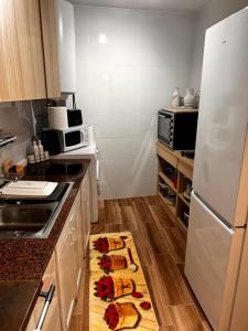 a kitchen with a white refrigerator and a counter with food at La Casina de MIRI in Tazones +12 photos