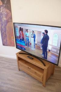 TV de pantalla plana en la parte superior de un soporte de madera en Altstadtleben - ABC164 en Wismar