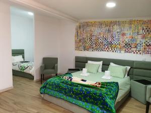 a bedroom with a bed and a painting on the wall at Gojim Casa Rural in Armamar +73 photos