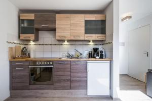 a kitchen with wooden cabinets and a sink at Newly renovated apartment in Bernau im Schwarzwald