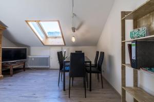 a dining room with a table and chairs and a skylight at Newly renovated apartment in Bernau im Schwarzwald