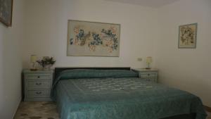 a bedroom with a bed and two night stands at Bright villa in Caorle with private garden in Caorle