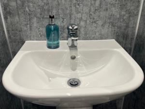 a white sink with a bottle on top of it at The Manor Inn Pub and Steakhouse, Fridaythorpe, Driffield in York