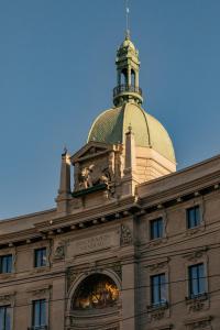 a building with a clock tower on top of it at Palazzo Cordusio, a Gran Melia Hotel in Milan