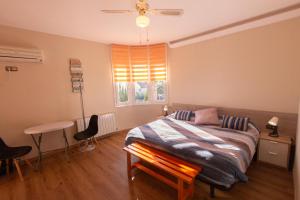 a bedroom with a bed and a table and a window at Catalunya Casas Stunning Villa with private pool 33 km to Barcelona in Senmanat +34 photos