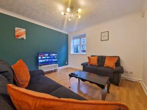 a living room with a couch and a tv at Free Parking: Perfect City Centre Flat in Manchester