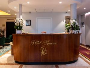 a reception desk at a hair salon with flowers at Hotel Minerve in Paris