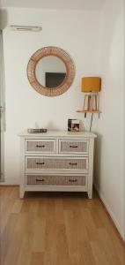 a white dresser with a mirror on the wall at Grand Appart T3, centre, gare, métro, parking privé in Toulouse