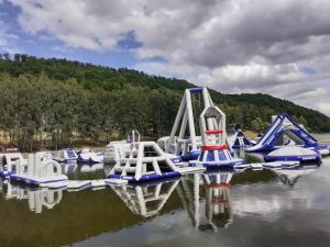 a group of inflatable slides in the water at Chata Otulina in Wünschelburg