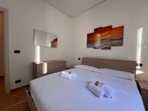 een slaapkamer met een groot wit bed met 2 kussens bij Relax & Mare in Rapallo