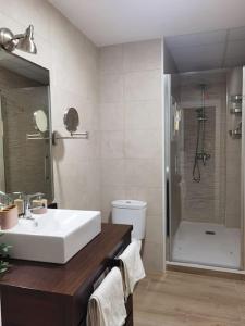 Un baño con lavabo blanco y ducha en Fantástico piso nuevo, Mentidero, en Cádiz
