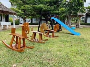 a group of childrens play equipment in the grass at 4 Corner Khaoyai in Mu Si