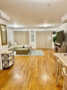 a living room with a couch and a table at Stylish Evergreen Apartment By Newark Airport in Newark