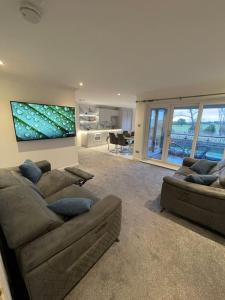 a large living room with two couches and a couch at 2bedroom apartment/steam room in Carnoustie