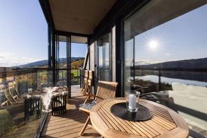a room with a table and chairs on a balcony at Åre View in Åre