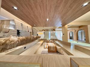 a living room with a large wooden ceiling at perBed Hostel-Taichung Station in Taichung