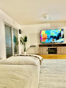 a bedroom with a flat screen tv on a wall at Stylish Evergreen Apartment By Newark Airport in Newark