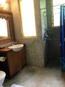 a bathroom with a sink and a shower at Limericks by the Sea in Savusavu +27 photos
