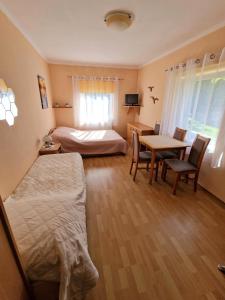 a bedroom with a bed and a table with a desk at Dom Gościnny Roksana in Rewal