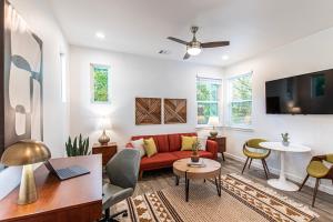 a living room with a red couch and a table at Cozy Studio Apartment in Prime Location in Austin