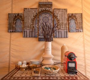 a table with a toaster and other items on it at Dihya desert camp in Merzouga