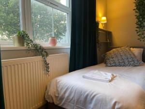 a bedroom with a white bed with a window at Single Bright Studio Flat in King's Cross in London