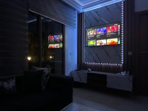 a living room with a couch and a television at MSVIP PERLA SAIDIA GH1 s in Saidia 
