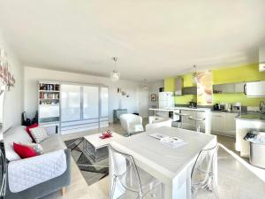 a kitchen and living room with a table and chairs at Petit Juas by Welcome to Cannes in Cannes
