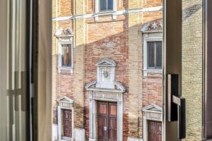 a view of a brick building from a window at San Marco Casa Vacanza in Osimo