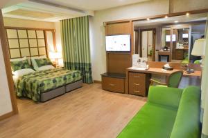 a hotel room with a bed and a desk at UNITED HOTEL INTERNATIONAL in Yaoundé