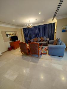 a living room with a couch and a table and chairs at فندق كارم الخبر - Karim Hotel Khobar in Al Khobar