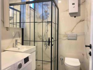a bathroom with a shower and a toilet and a sink at Jasmin 4 in Alanya +12 photos