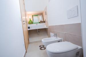 a bathroom with a toilet and a sink at Capperi !! Holiday Rentals in Morciano di Leuca