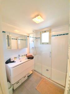 a bathroom with a white sink and a shower at Petit Juas by Welcome to Cannes in Cannes