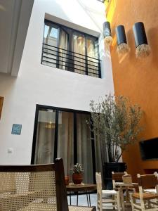 a room with a table and chairs and a building at RIAD LE M neuf et contemporain in Marrakech