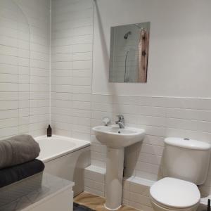 a white bathroom with a toilet and a sink at Comfortable stunning 2-Bed Apartment in Colchester in Colchester