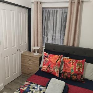 a bedroom with a bed with two pillows and a window at Stunning 2-Bed Apartment in London Dagenham in Dagenham