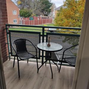 a table and two chairs on a balcony at Stunning 2-Bed Apartment in London Dagenham in Dagenham